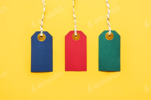Preview: Colorful blank sale tags on yellow background. Black Friday and sales concept. Top view, copy space