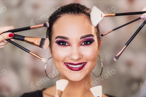 Preview: Cute Woman With Nice Makeup Surrounded By Make up Brushes