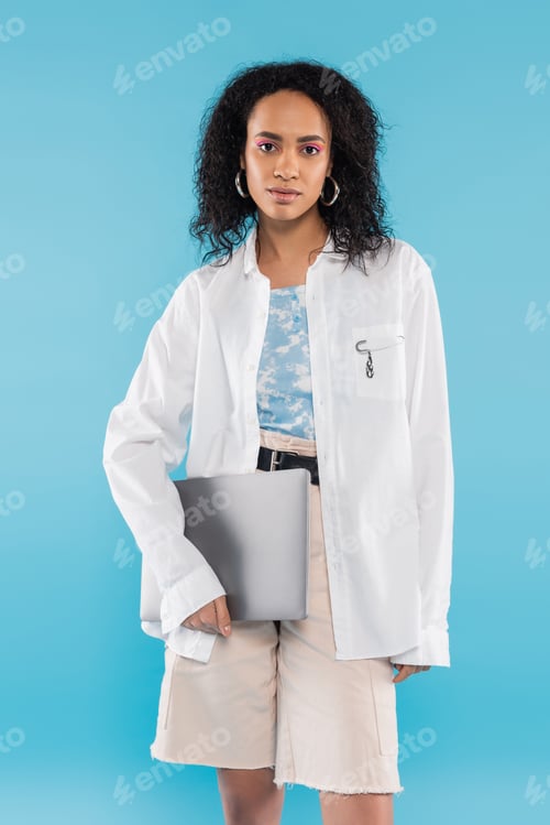 Preview: Young Woman with Laptop on Light Blue Background