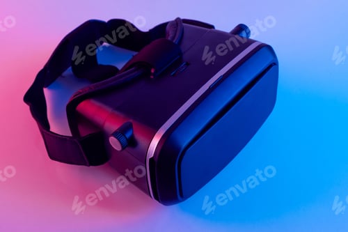 Preview: Black VR glasses mask on neon color background. Virtual reality headset close up