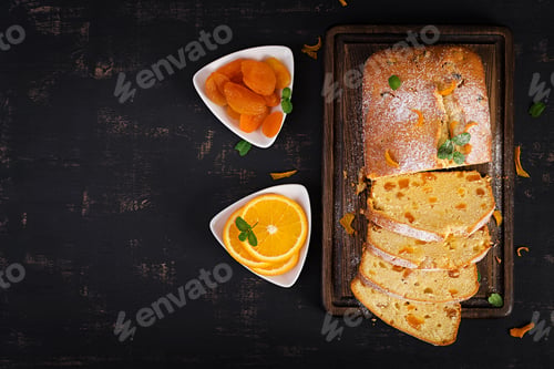Preview: Orange cake with dried apricots and powdered sugar. Top view