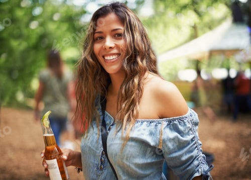Preview: Aphrodite...Portrait of a pretty young woman enjoying a drink at an outdoors music festival.