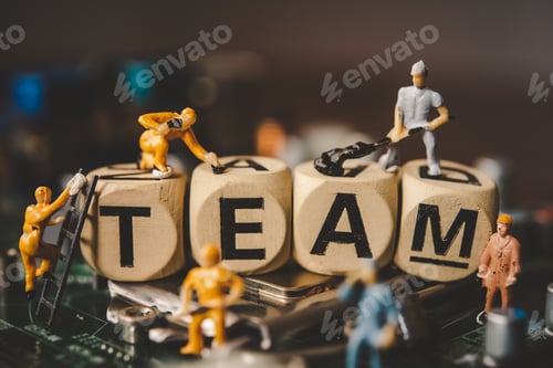 Preview: Miniature people or small figure worker on wood block with the word "TEAM"