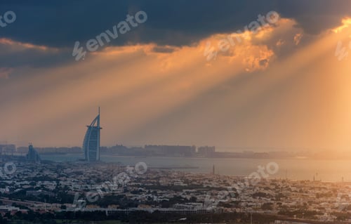 Preview: Cityscape of Dubai, United Arab Emirates at dusk with the Burj Al Arab skyscraper in the distance.