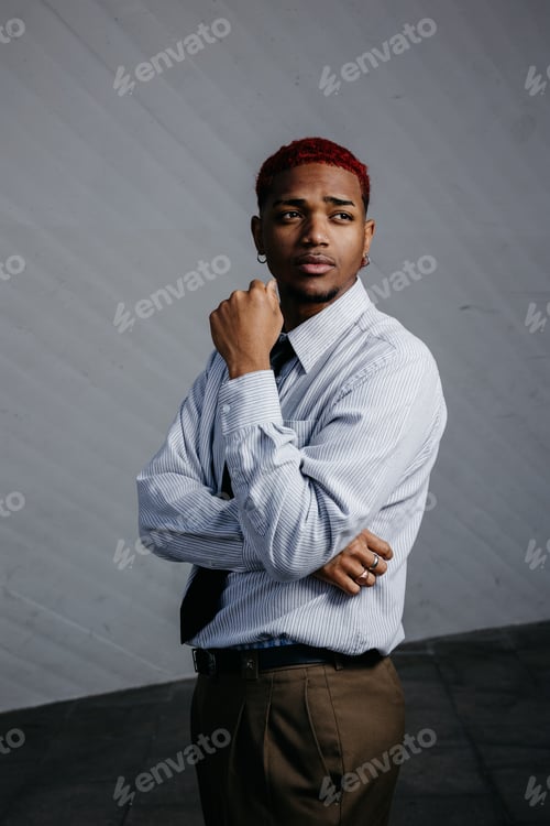 Preview: Portrait of a young black boy in interesting pose on spotted gray background