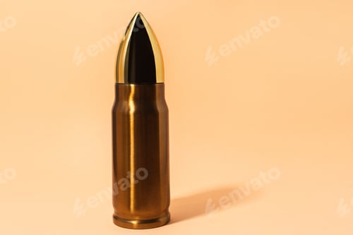 Preview: Big and shiny bullet against beige background