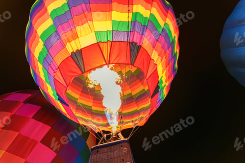 Preview: Colorful hot air balloon with flame burning in the night