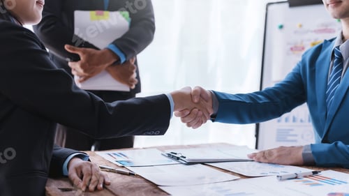 Preview: Business success. Business people handshake agreement confirmed in the investment business.