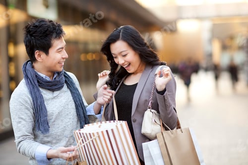 Preview: Excited young woman receiving a surprise gift from boyfriend