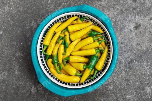 Preview: Yellow hot peppers on green bowl