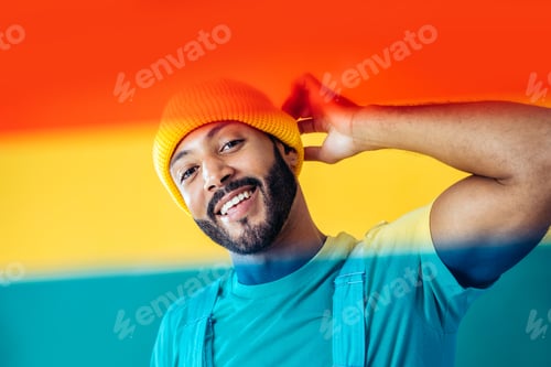 Preview: Man posing on colored backgrounds in studio wearing trendy clothes