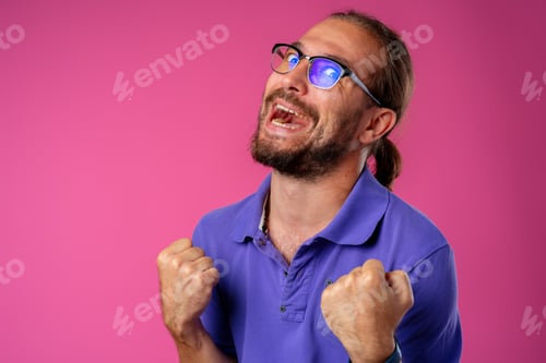 Preview: Overjoyed funny bearded man in glasses celebrating success