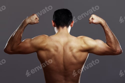 Preview: Young muscular guy over gray background