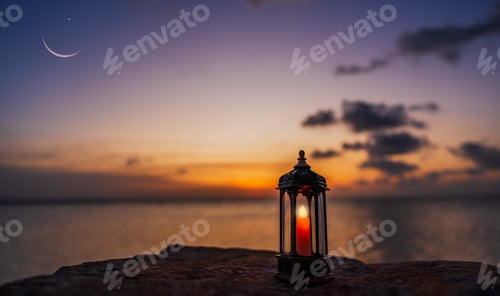 Preview: Lantern lamp on rock beach sunset sky blurred crescent over sea in the evening, Religion well space
