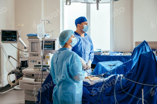 Preview: Two surgeon doctors performing operation uterus removal in hospital.