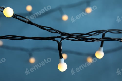 Preview: Beautiful Christmas lights on color background, closeup
