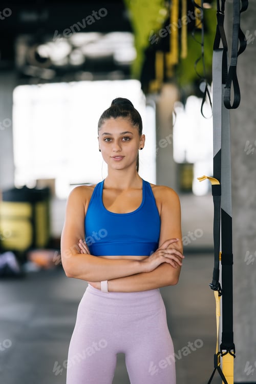Preview: Beautiful young woman posing for the camera in the gym