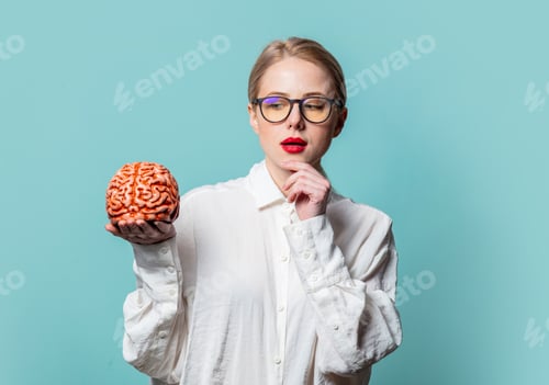 Preview: Portrait of beautiful blonde in white shirt with human brain on blue background