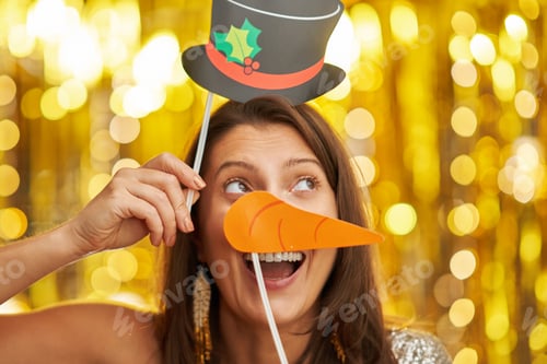 Preview: Young woman over gold background with photo booth accessories