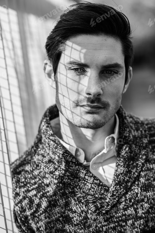 Preview: Attractive young handsome man, model of fashion in urban backgro