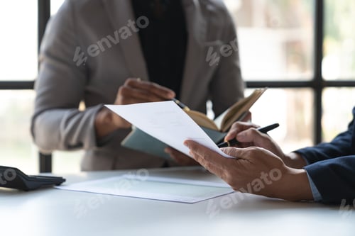 Preview: Two young Asian businessmen analyzing Calculate and discuss and brainstorm data, charts, graphs Taki