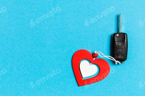 Preview: Top view of car key and wooden heart on colorful background. Saint Valentine's Day concept