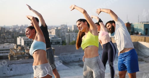 Preview: Fitness, sport, training and lifestyle concept. Group of fit people exercising outdoor
