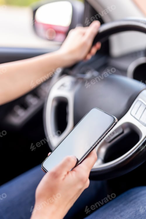 Preview: Woman using phone and driving a car