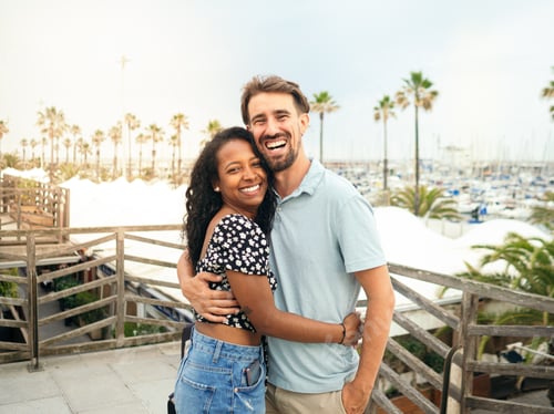 Preview: Happy diverse smiling heterosexual young couple looking at camera during vacation