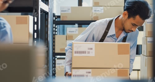 Preview: Asian business partner man wear formal uniform shirt carry cardboard box stack from shelf prepare.
