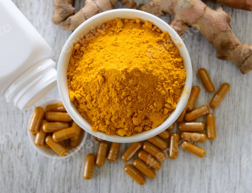 Preview: Turmeric powder and turmeric capsules on wooden background