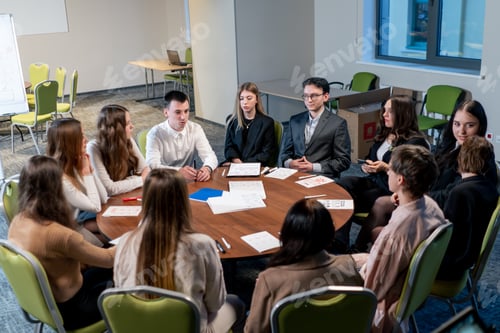 Preview: colleagues at a large table in the company discuss a concept for a new project during a brainstorm