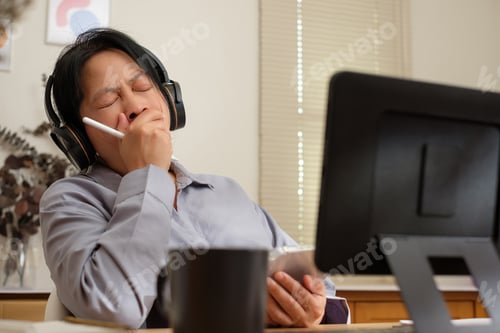 Preview: asian woman yawn when video conference meeting at home