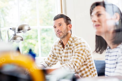 Preview: Two designers having meeting at desk in creative studio