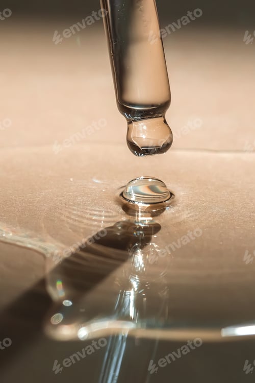Preview: A pipette of cosmetic gel on a beige background.