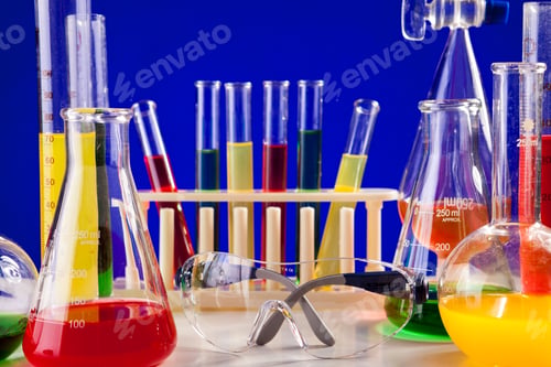 Preview: Chemistry lab set with colored chemicals in it on a table over b