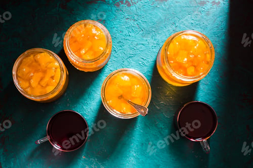 Preview: Banks with pineapple jam and tea on the table top view