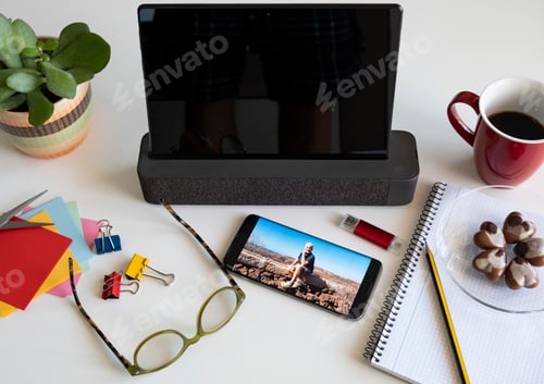 Preview: Corner of the table with tablet and mobile phone. Desk office - photograph of a senior man