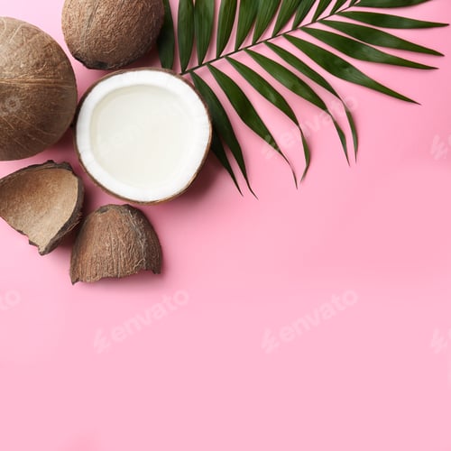 Preview: Fresh coconuts and palm leaf on pink background, flat lay. Space for text