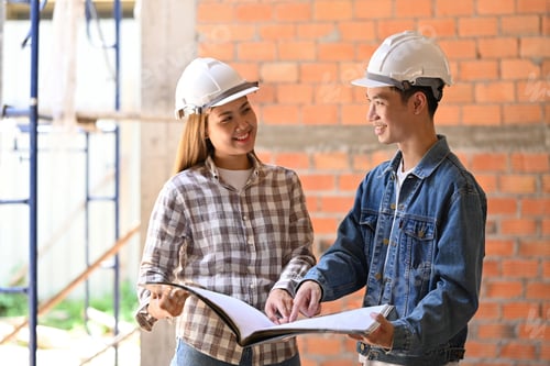Preview: Two satisfied architects standing at building site and discussing construction project.