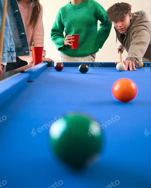 Preview: Close Up Of Group Of Teenage Girls And Boys At Home Playing Game Of Pool Together
