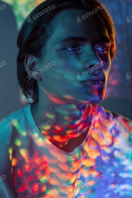 Preview: Young man illuminated with bright lights