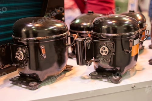Preview: Close up black refrigerator compressors.