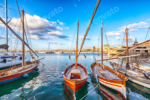 Preview: Summer view of the Alghero Marina yacht port at the Gulf of Alghero with anchored sailboats