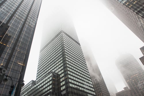 Preview: Skyscrapers shrouded in fog in an urban setting.