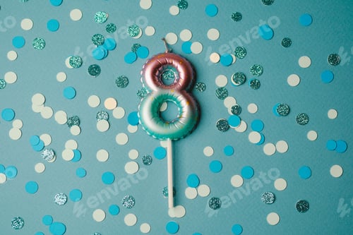 Preview: Colorful number eight birthday candle on a confetti backdrop