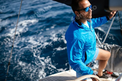 Preview: Handsome strong man sailing with his boat