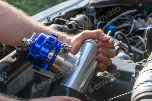 Preview: Hands of car mechanic with wrench in garage, selective focus