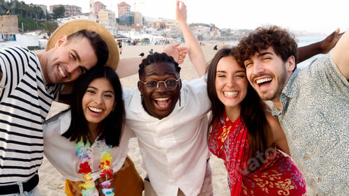 Preview: Group of diverse friends laughing and having fun at the beach