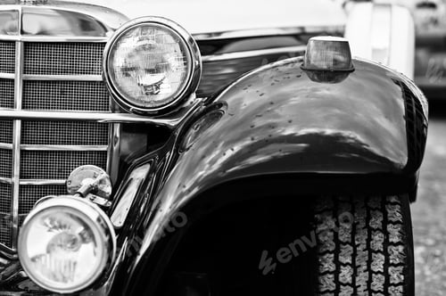 Preview: Old vintage car headlight close up. Black and white photo